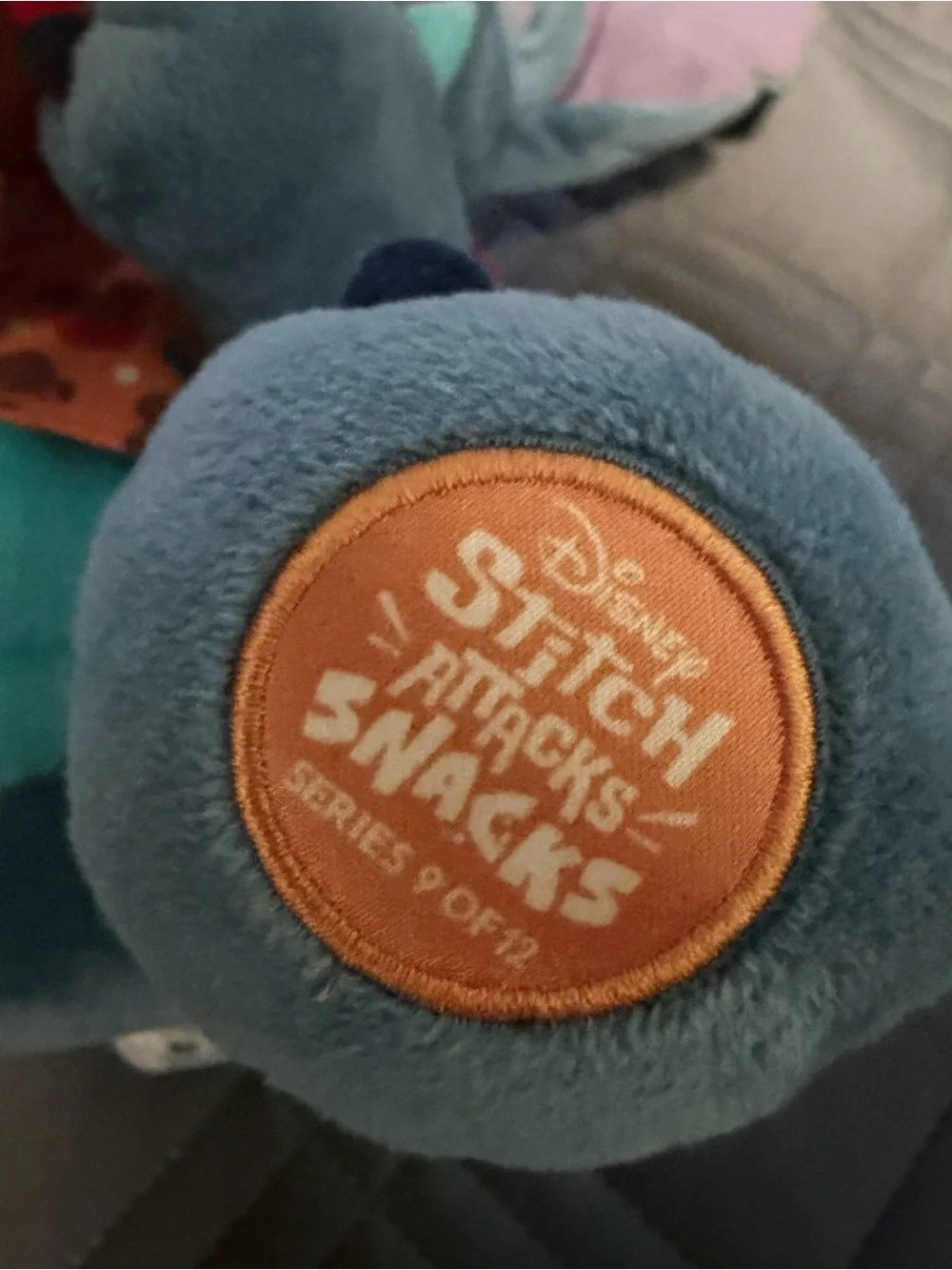 Disney Blue Stitch Plush with Pink Ears Holding Red & Brown Treat